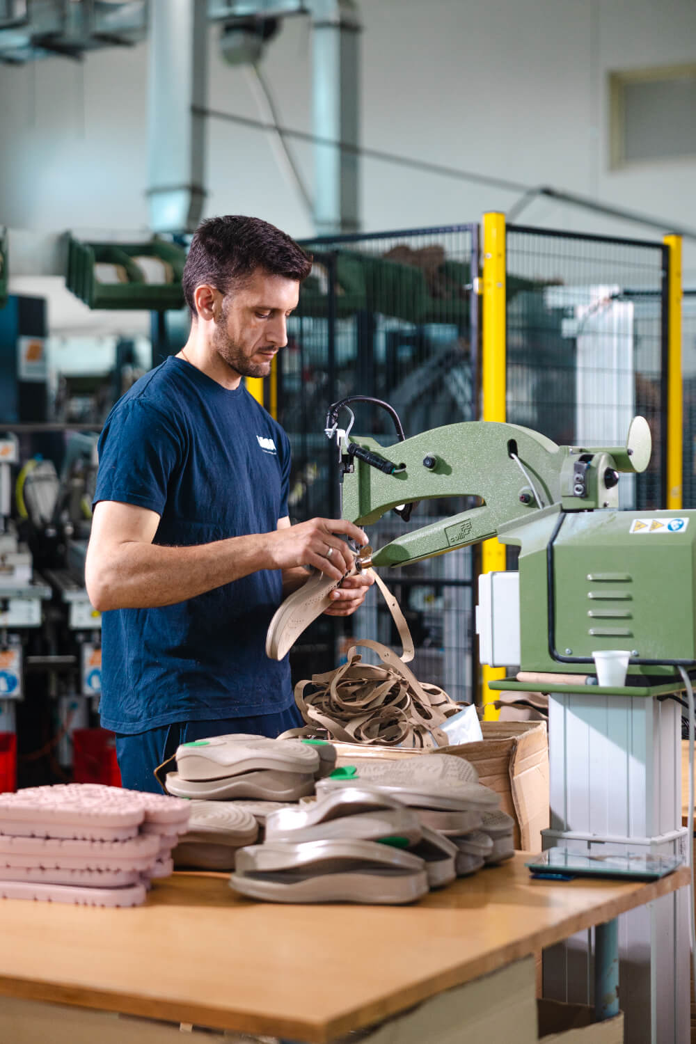 Worker trimming sole leather