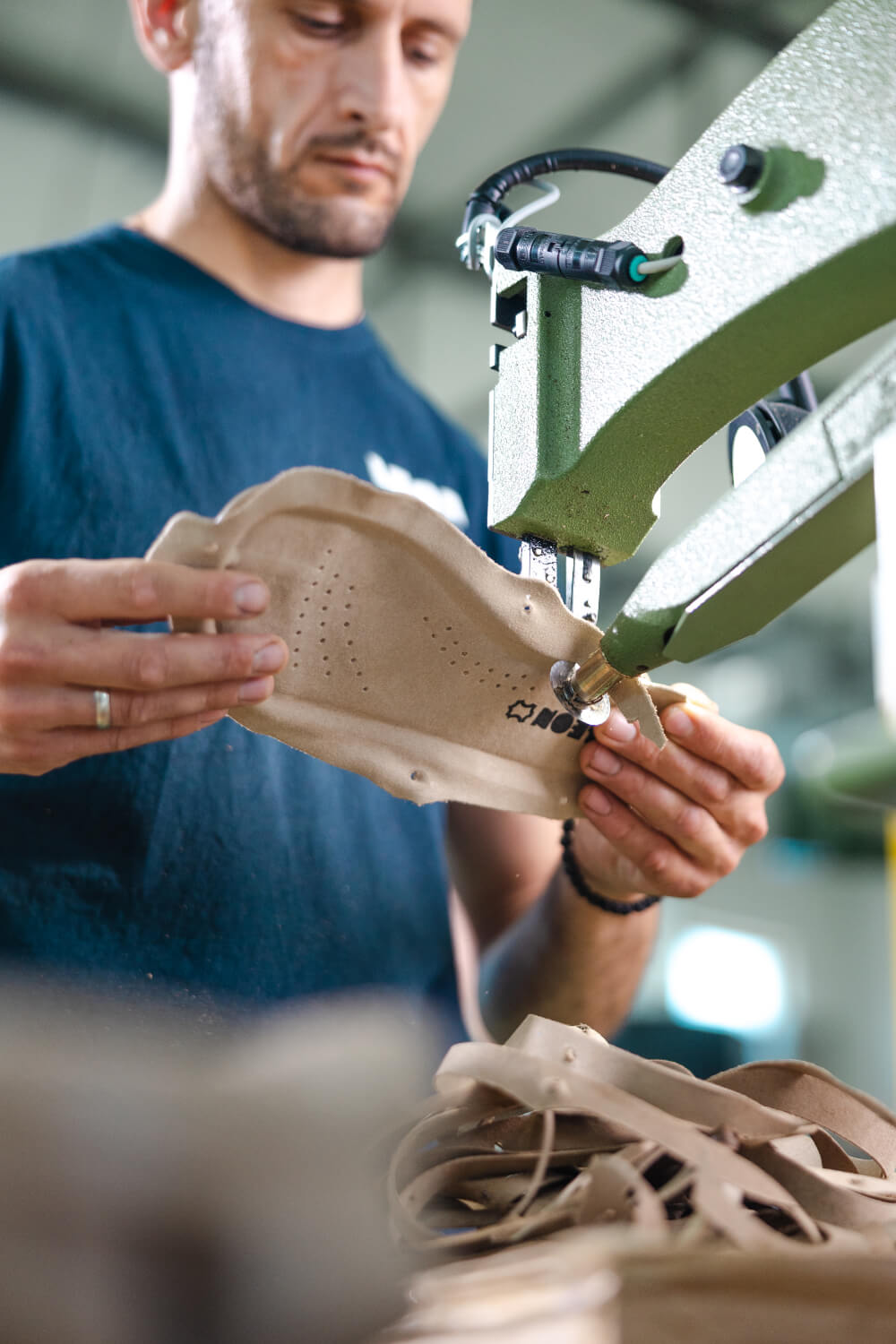 Close-up of leather perforation at LEON factory
